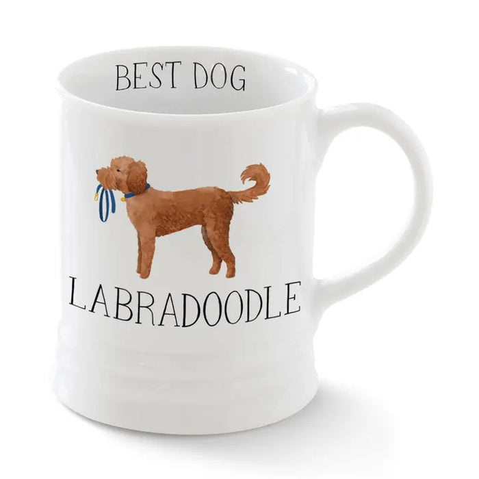 The FRINGE STUDIO - CERAMIC LABRADOODLE MUG by PET SHOP BY FRINGE STUDIO features a brown Labradoodle with a blue leash, "BEST DOG" above and "LABRADOODLE" below—ideal as a quirky gift or your go-to coffee mug.