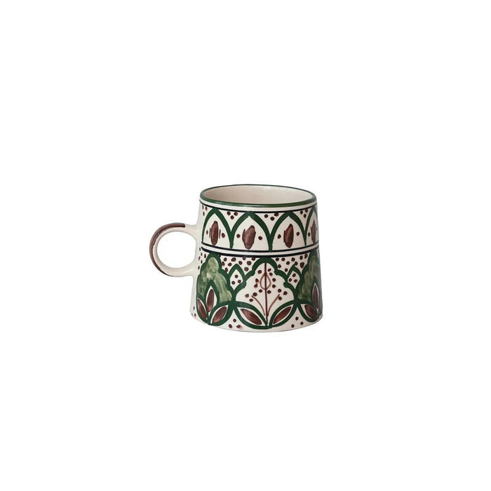 The CREATIVE COOP HAND-PAINTED STONEWARE MUG showcases a green and brown floral pattern with geometric and leaf motifs encircling its slightly flared body. This rustic mug features a comfortable handle and beautifully detailed decorative art, all carefully hand-painted on durable stoneware.