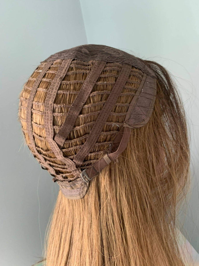 Close-up of the interior cap construction of a Straight Brown Wig, showcasing the wefts and adjustable straps.