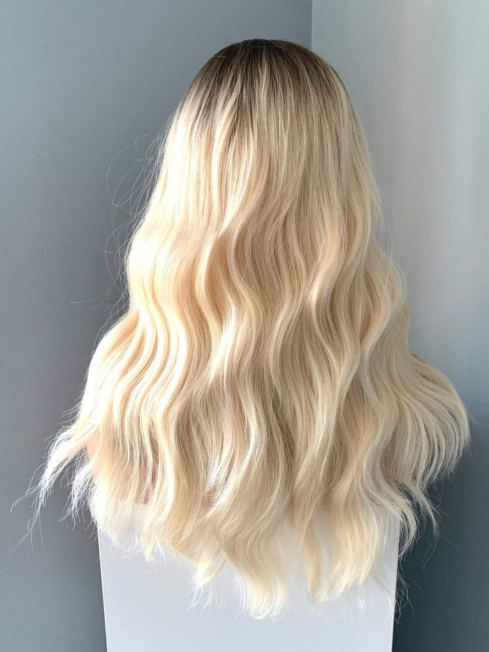 Back view of the Krista Wavy Blonde Wig with Bangs showcasing soft waves and a natural look in blonde color.