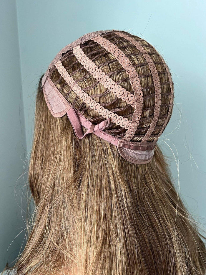 Back view of a wig cap with ribbons and natural brown curled hair, showcasing the structure of a Brown Curled Wig.