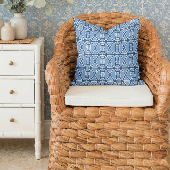 The LOOM & CLOTH Lattice Tailored Pillow in Blue features a striking blue and white geometric pattern with intersecting lines and shapes on a crisp white background. Made from soft cotton with tailored edges, this decorative square pillow brings a modern flair to any room.