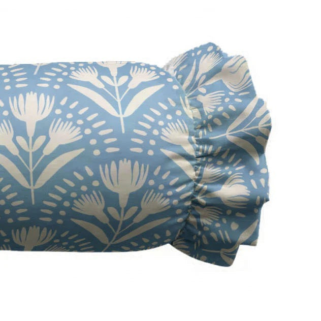 The LOOM AND CLOTH - SERENA RUFFLED BOLSTER PILLOW by LOOM & CLOTH features a cylindrical silhouette with ruffled ends, upholstered in light blue fabric adorned with a white floral pattern, bringing timeless elegance and vintage-chic style to your decor.