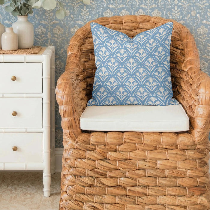 The LOOM AND CLOTH - SERENA TAILORED PILLOW by LOOM & CLOTH is a square cotton pillow featuring a blue background with a repeating white floral pattern of stylized flowers and leaves arranged in symmetrical rows. This decorative pillow brings an elegant touch to any room.