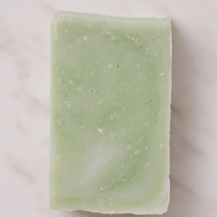 Green soap bar on a light beige background