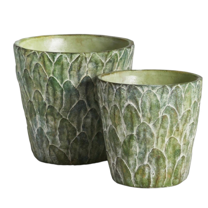 The NAPA HOME AND GARDEN - FELDBURG POT, LARGE is a green ceramic cachepot with a textured, leaf-like pattern and a slightly flared rim, perfect for adding decorative charm to your space.
