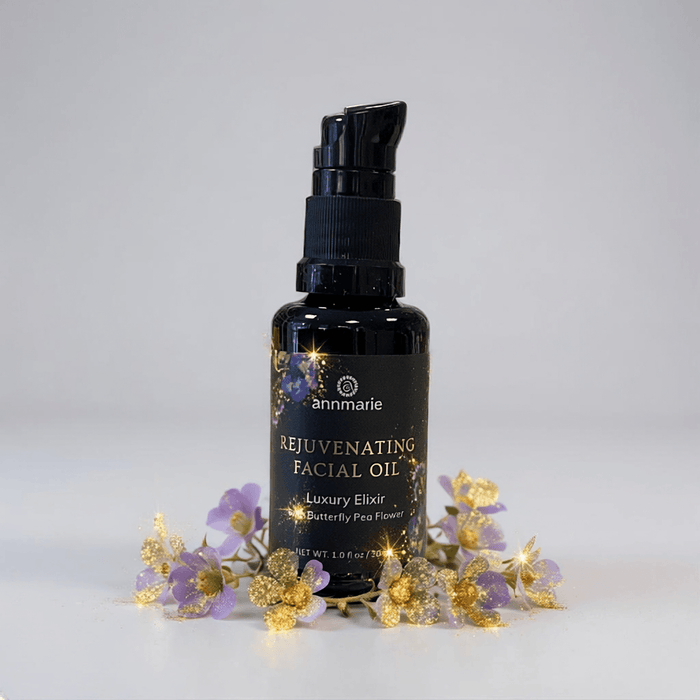 Black facial oil bottle with decorative flowers on a light gray background