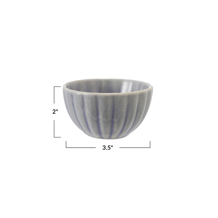 The CREATIVE COOP STONEWARE RIBBED BOWL IN LIGHT BLUE features a small, round design with vertical ridges and a glossy reactive glaze—ideal for adding cottagecore charm to your decor.
