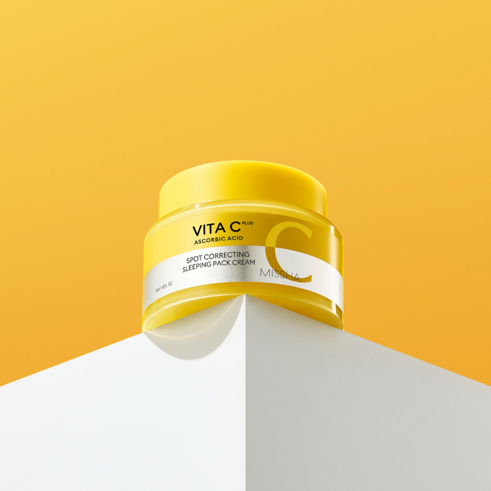 Yellow jar of VITAC skincare product on a yellow and white background