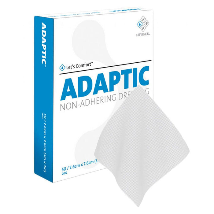 A non-adhering Adaptic dressing rests atop its box; the box displays product information and the company logo.