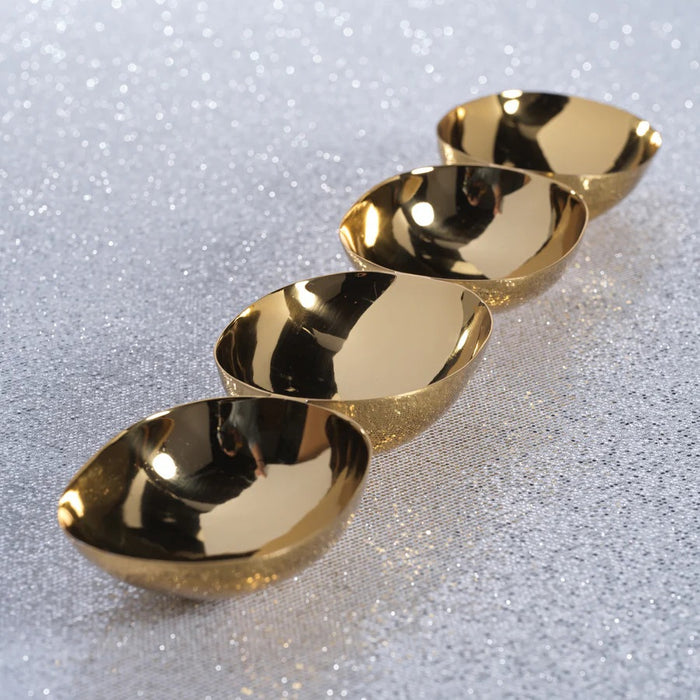 The ZODAX 4-BOWL NUT/SNACK SERVER – POLISHED GOLD features four gleaming gold-colored oval bowls arranged in a straight horizontal line on a white background, forming an elegant server that also serves as a striking sculptural centerpiece.
