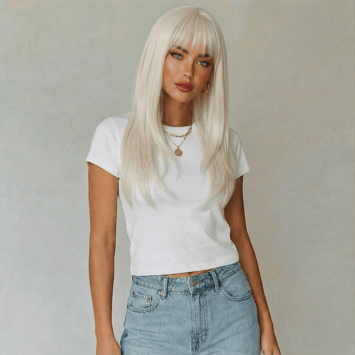 Woman wearing a white t-shirt and blue jeans with a plain background