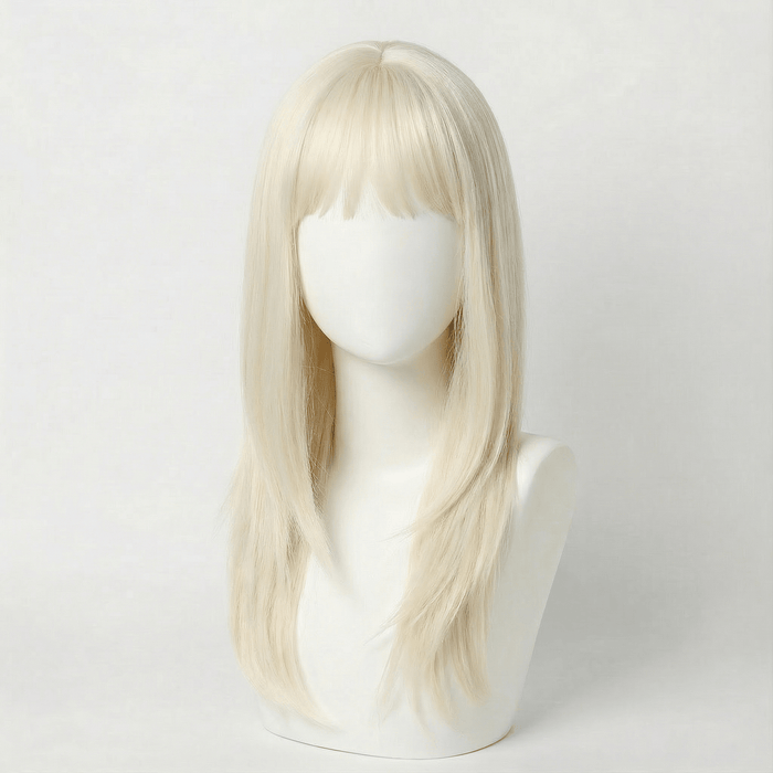 Blonde wig on a mannequin head against a white background