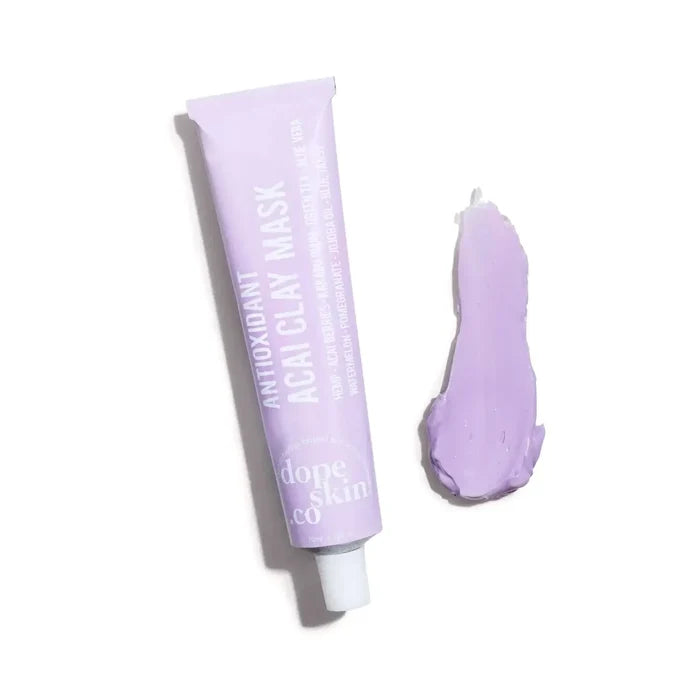Purple clay mask tube with a small amount of mask on a white background