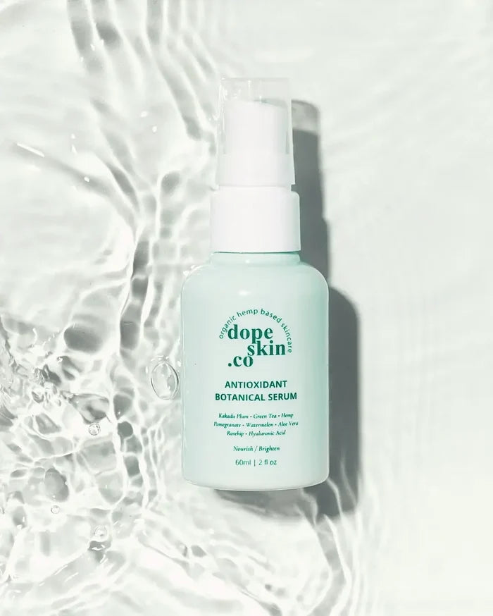 Skincare serum bottle with 'dope skin co' branding on a textured white background