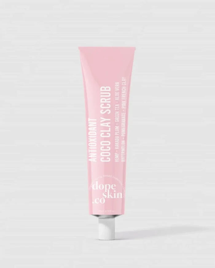Pink tube of 'dope skin co' scrub on a white background