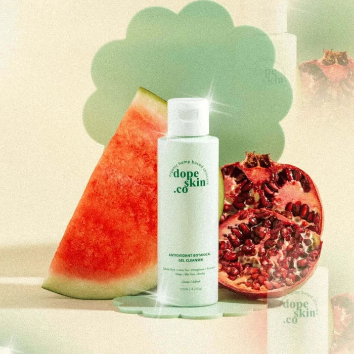 Skincare bottle labeled 'dope skin co' with watermelon and pomegranate on a light background