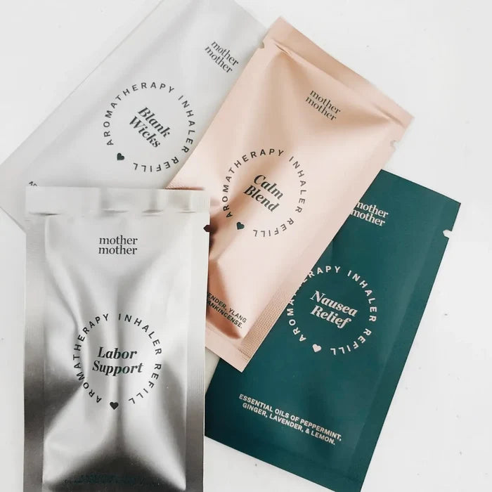 Three 'mother mother' aromatherapy inhaler packets in different colors on a light background.