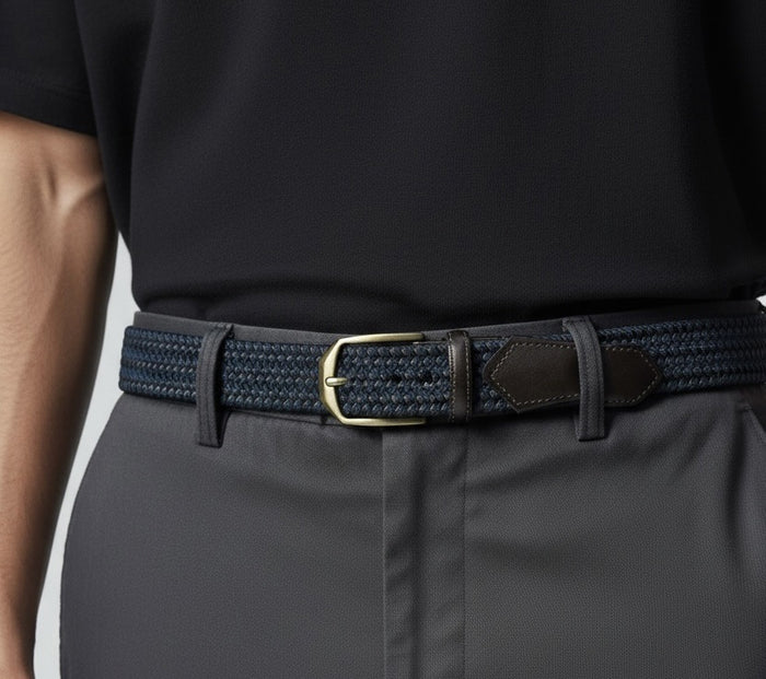 A person wearing a black shirt and grey pants with the ATHISON Braided Leather and Wool Stretch Belt in dark brown and blue.