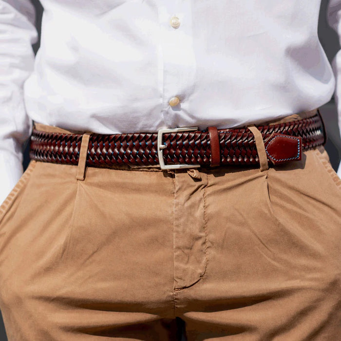 The ATHISON - BRAIDED LEATHER BELT IN BROWN AND LIGHT BLUE by ATHISON features Italian craftsmanship, a silver rectangular buckle, and braided recycled leather with a stitched accent near the buckle for a refined look.