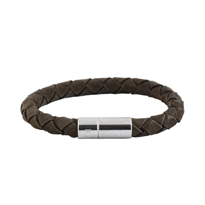 The ATHISON - BRAIDED NUBUCK BRACELET IN DARK BROWN by ATHISON is crafted in Italy, showcases a silver cylindrical clasp, and is displayed against a white background.