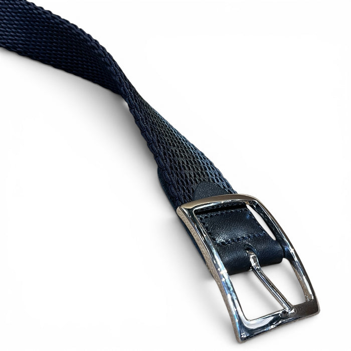 A close-up of the ATHISON reversible stretch belt featuring indigo, manatee, and light blue stripes reversing to solid indigo, with a textured finish and a silver rectangular buckle on a white background.