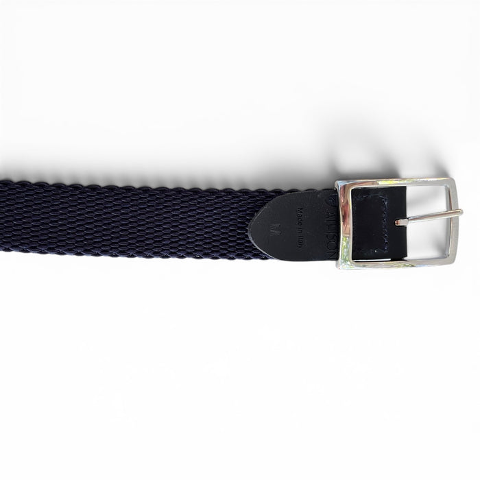 A close-up of the ATHISON reversible stretch belt featuring indigo, manatee, and light blue stripes reversing to solid indigo, with a textured finish and a silver rectangular buckle on a white background.