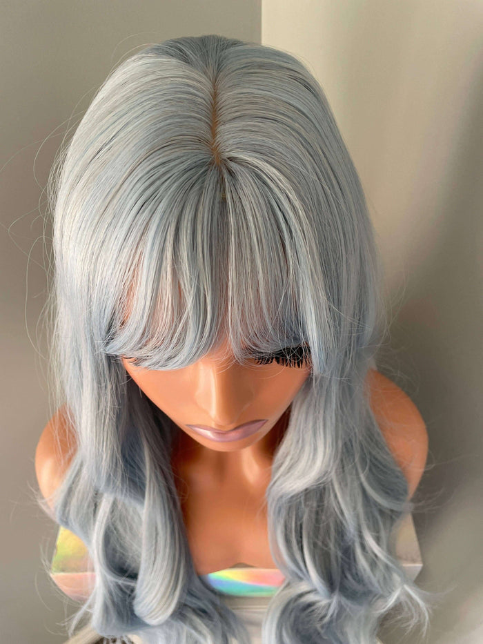 Azura Long Light Pastel Blue Wig featuring soft waves and bangs in a dreamy pastel blue shade, perfect for bold styles.