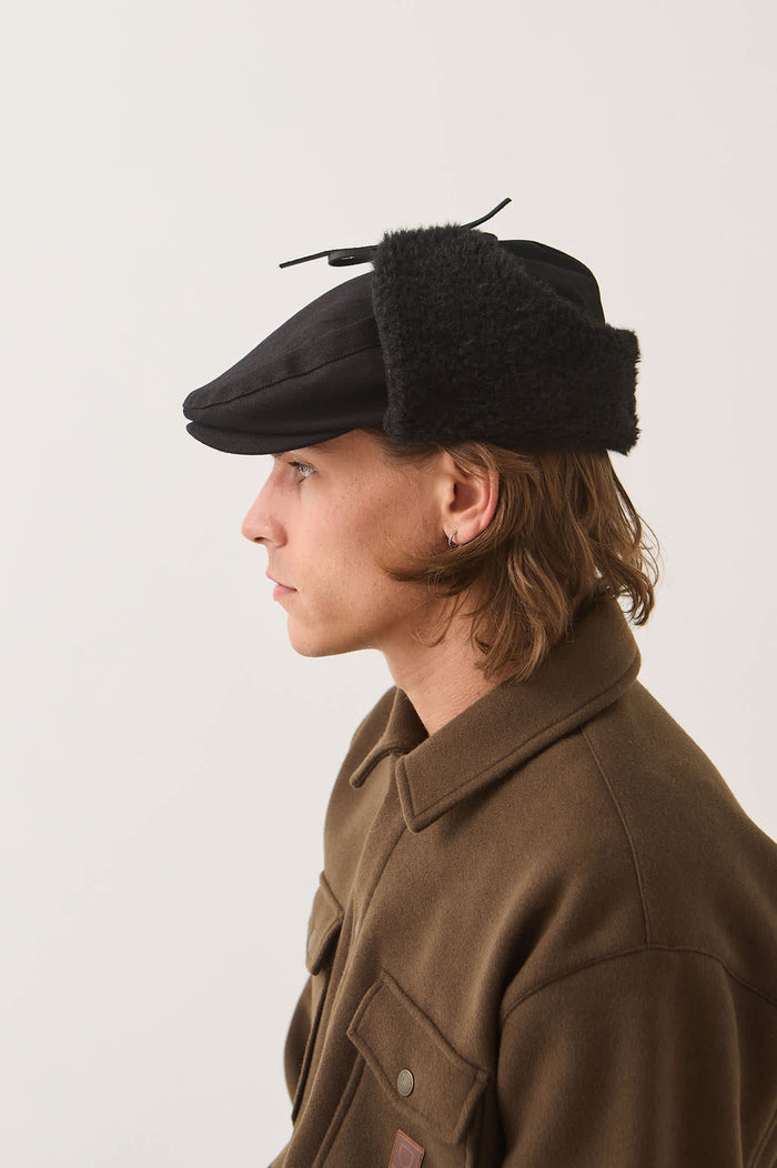 Unisex Barrel Earflap Snap Cap in the color Black/Black - Men's Side View