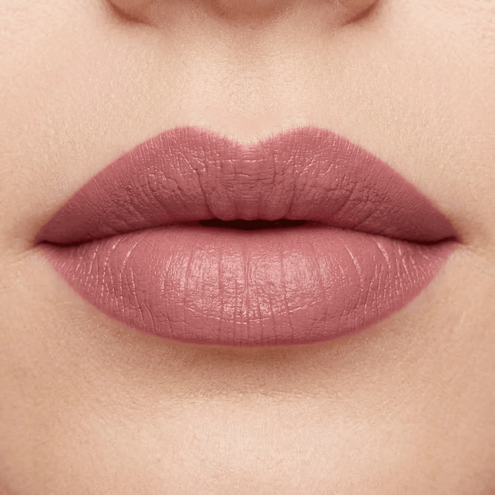 Close-up of a person's lips with a soft pink lipstick