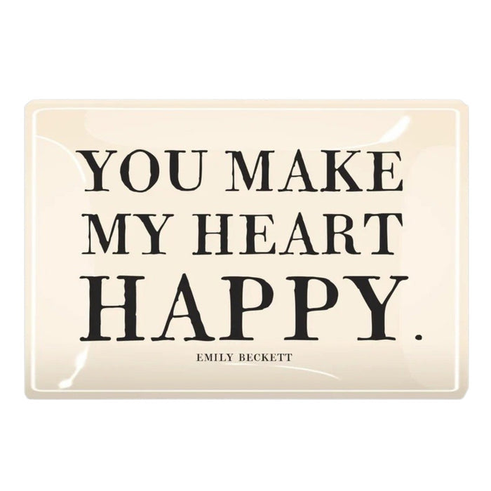 A cream-colored glass tray from BENS GARDEN features bold black lettering that reads, "YOU MAKE MY HEART HAPPY," with "EMILY BECKETT" inscribed below in smaller print. Reminiscent of the handcrafted style Ben’s Garden is known for, the BEN’S GARDEN - YOU MAKE MY HEART HAPPY DECOUPAGE GLASS TRAY makes a thoughtful gift or a charming accent for any space.