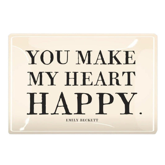 A cream-colored glass tray from BENS GARDEN features bold black lettering that reads, "YOU MAKE MY HEART HAPPY," with "EMILY BECKETT" inscribed below in smaller print. Reminiscent of the handcrafted style Ben’s Garden is known for, the BEN’S GARDEN - YOU MAKE MY HEART HAPPY DECOUPAGE GLASS TRAY makes a thoughtful gift or a charming accent for any space.