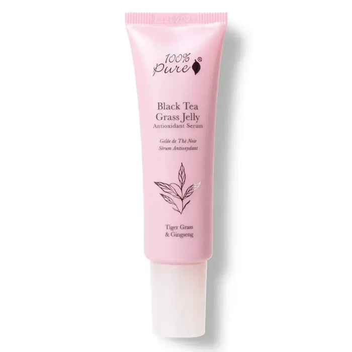 Pink skincare serum tube labeled '100% Pure Black Tea Grass Jelly' on a white background