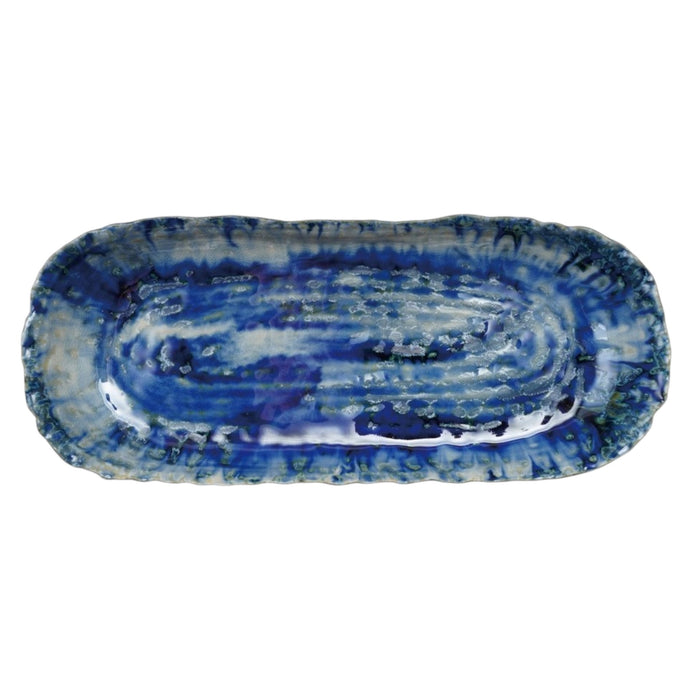 The CREATIVE COOP BLUE STONEWARE ORGANIC-SHAPED PLATTER features a wavy, textured edge and is shown from top and side angles. Its hand-crafted appeal is enhanced by a reactive crackle glaze in blue with white accents.