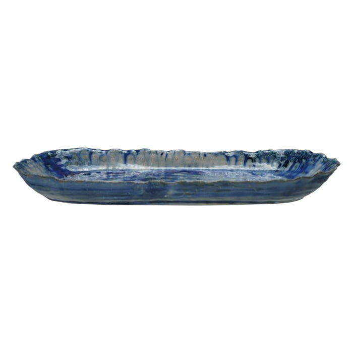 The CREATIVE COOP BLUE STONEWARE ORGANIC-SHAPED PLATTER features a wavy, textured edge and is shown from top and side angles. Its hand-crafted appeal is enhanced by a reactive crackle glaze in blue with white accents.