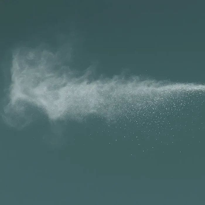 White powder cloud on a dark green background