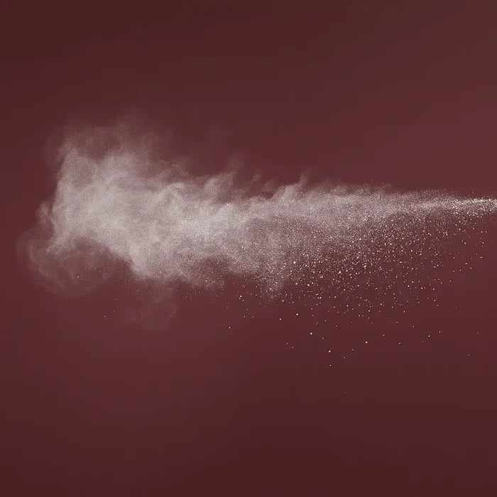 White powder cloud on a dark red background