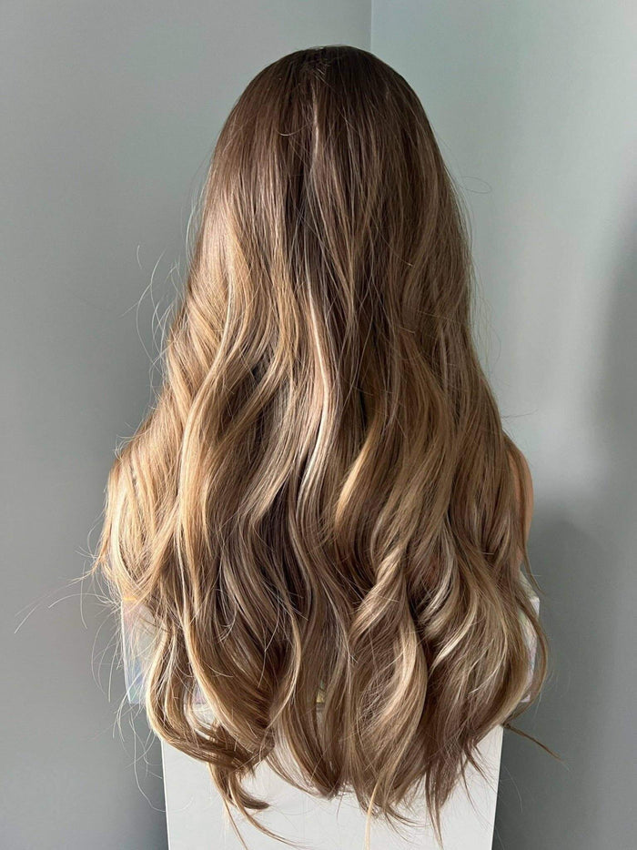 Brianna Long Brown Wig With Highlights showcasing soft brown waves and blonde highlights.
