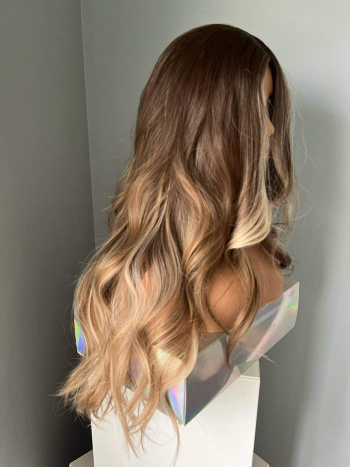 Brianna Long Brown Wig With Highlights showcasing soft brown waves and blonde highlights, perfect for effortless elegance.