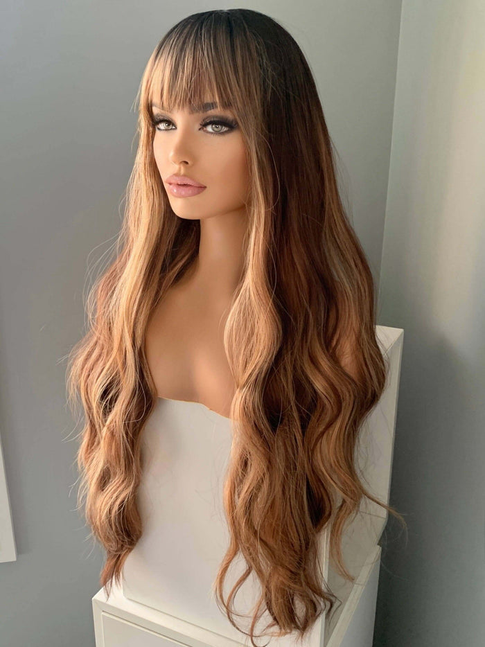 Highlighted Wig featuring Carmen Long Highlighted Brown Body Wave with Bangs, showcasing volume and style.