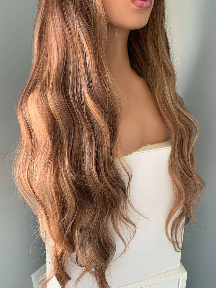 Highlighted Wig featuring long, soft body waves in brown with dimension and volume, perfect for a glamorous look.