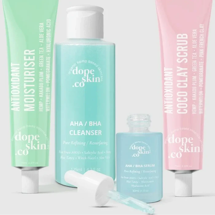 Four skincare products from dope skin co on a light gray background