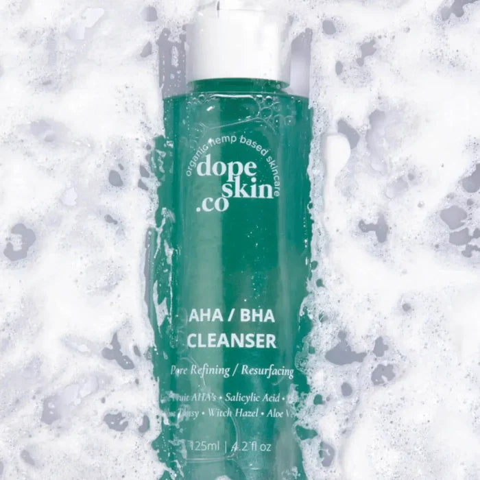 Dope Skin Co AHA/BHA Cleanser bottle on a textured white background