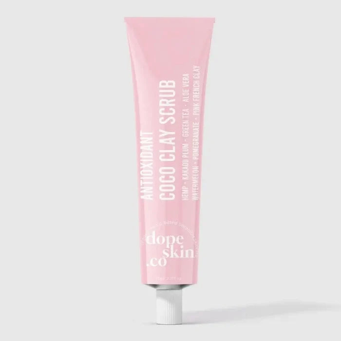 Pink tube of COCO CLAY SCRUB by dope Skin co on a light gray background
