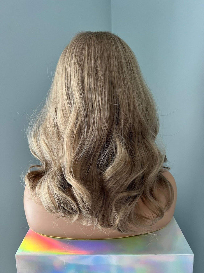 Back view of Dana Short Blonde Wig with Highlights, showcasing soft waves and a stylish length.