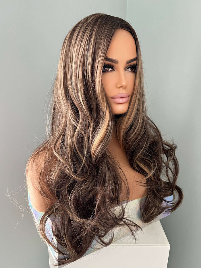 Long brown curled wig with highlights featuring cascading curls and a layered style for added volume.