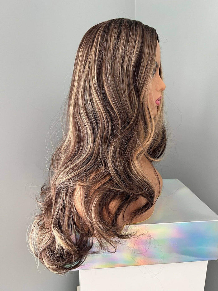 Side view of Devon Long Brown Curled Wig With Highlights showcasing cascading curls and golden caramel highlights.