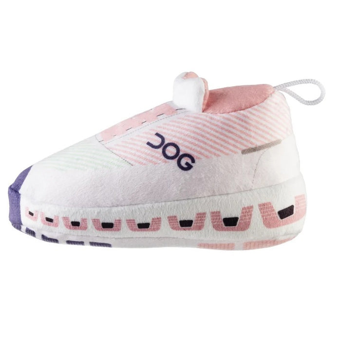 Introducing the DOG WORKOUT SHOE DOG TOY from HAUTE DIGGITY DOG—a plush slipper-shaped toy styled like a pink and white sneaker with "DOG" written on the side, a thick sole, and a handy loop at the back, all designed to mimic a fun workout shoe for playful pups.