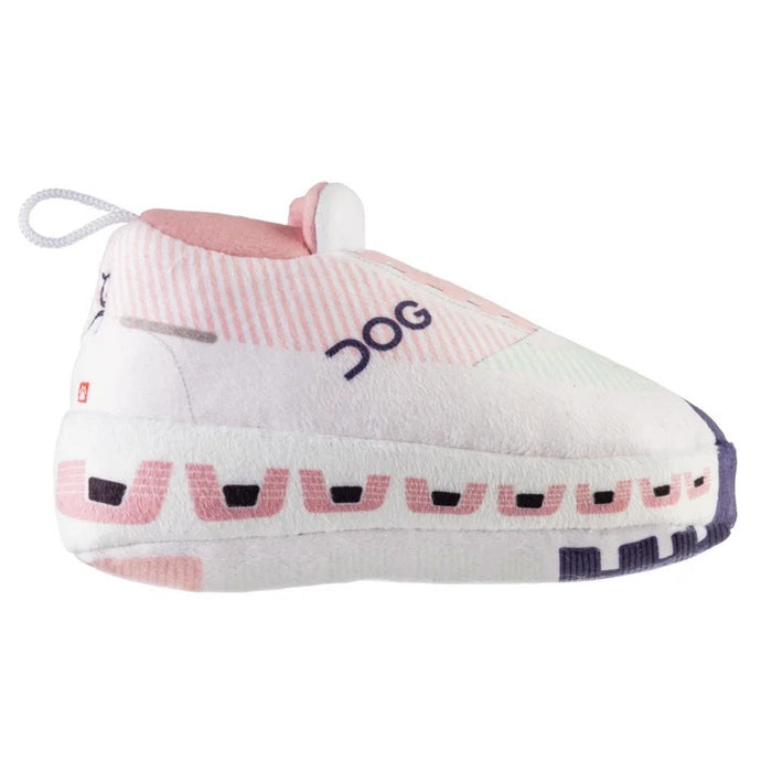 Introducing the DOG WORKOUT SHOE DOG TOY from HAUTE DIGGITY DOG—a plush slipper-shaped toy styled like a pink and white sneaker with "DOG" written on the side, a thick sole, and a handy loop at the back, all designed to mimic a fun workout shoe for playful pups.