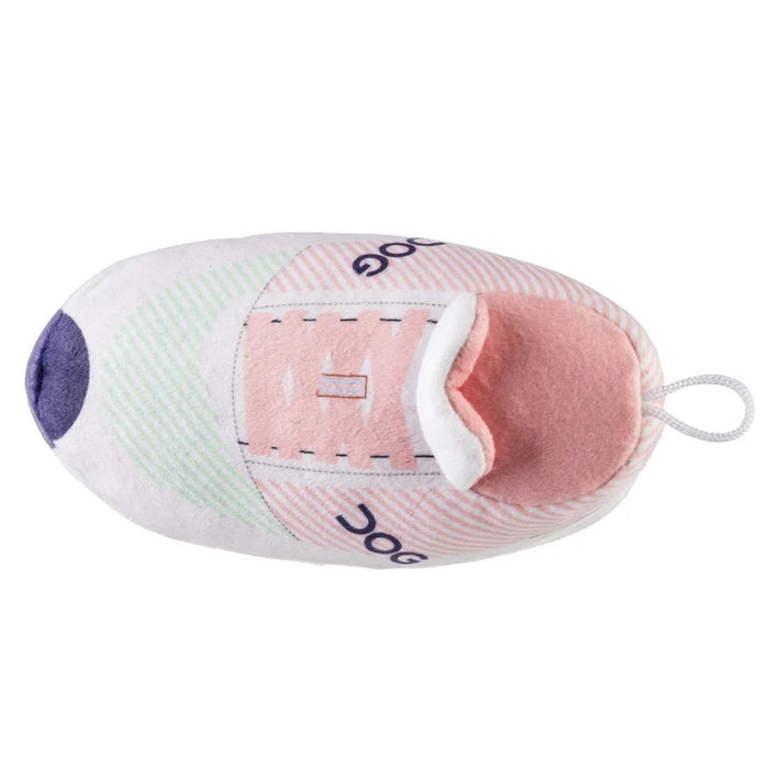 Introducing the DOG WORKOUT SHOE DOG TOY from HAUTE DIGGITY DOG—a plush slipper-shaped toy styled like a pink and white sneaker with "DOG" written on the side, a thick sole, and a handy loop at the back, all designed to mimic a fun workout shoe for playful pups.